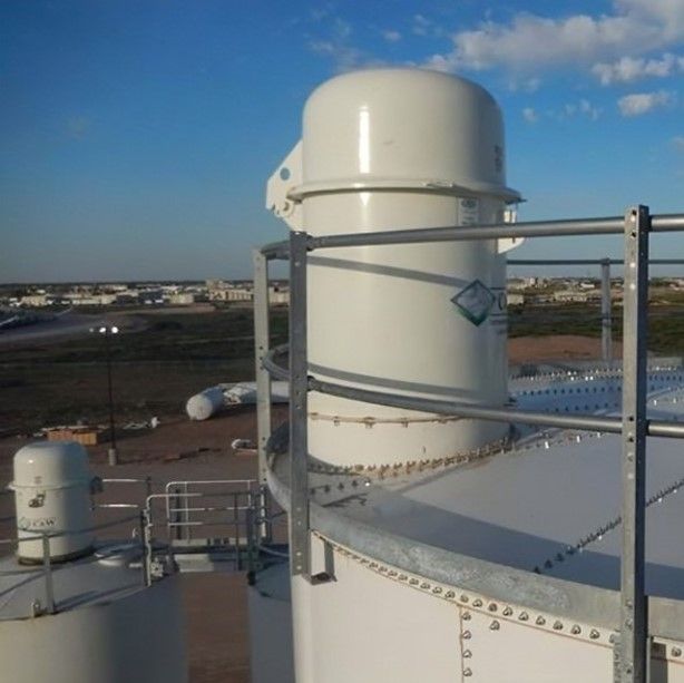 A large white tank sitting on top of a building.