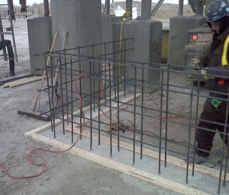 A construction worker is working on the concrete.