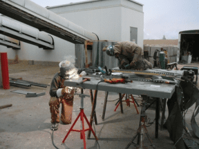 Two men working on a metal project.