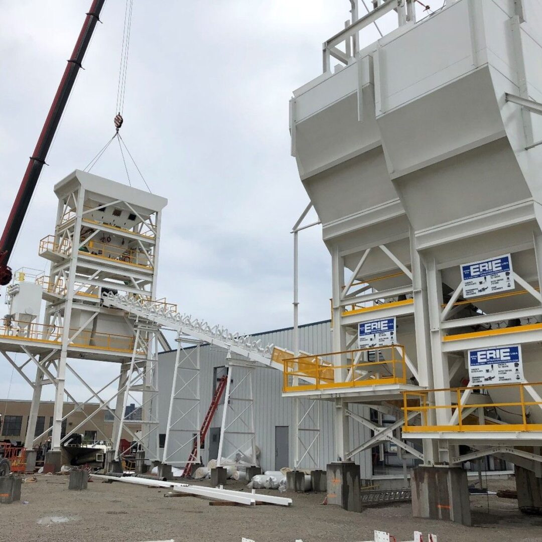 A crane is lifting the cement into place.