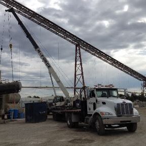 A crane is being used to lift a truck.